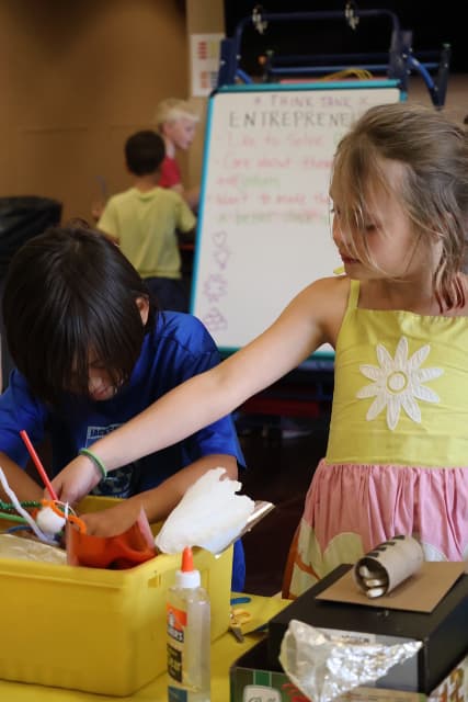 Young Girl Building a Prototype from Recycled Materials
