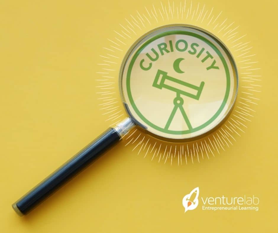 A magnifying glass focuses on the word "Curiosity" and an illustration of a telescope against a yellow background. The "venturelab Entrepreneurial Learning" logo is at the bottom right, highlighting their dedication to youth entrepreneurship education.