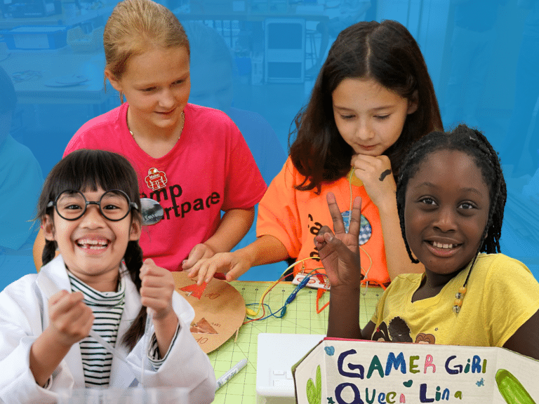 Four girls are engaged in a STEM activity: three working with circuits, and one in a lab coat smiling and gesturing enthusiastically, embodying the spirit of entrepreneurship education at its best.