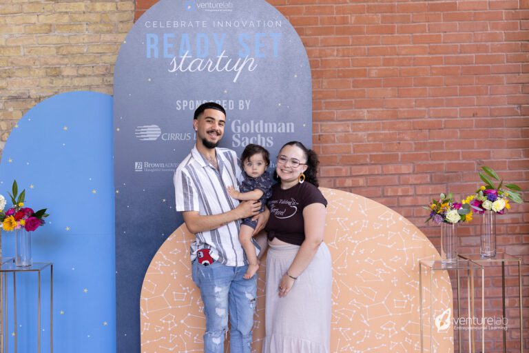 A young couple stands in front of a 