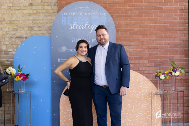 Two people standing in front of a 