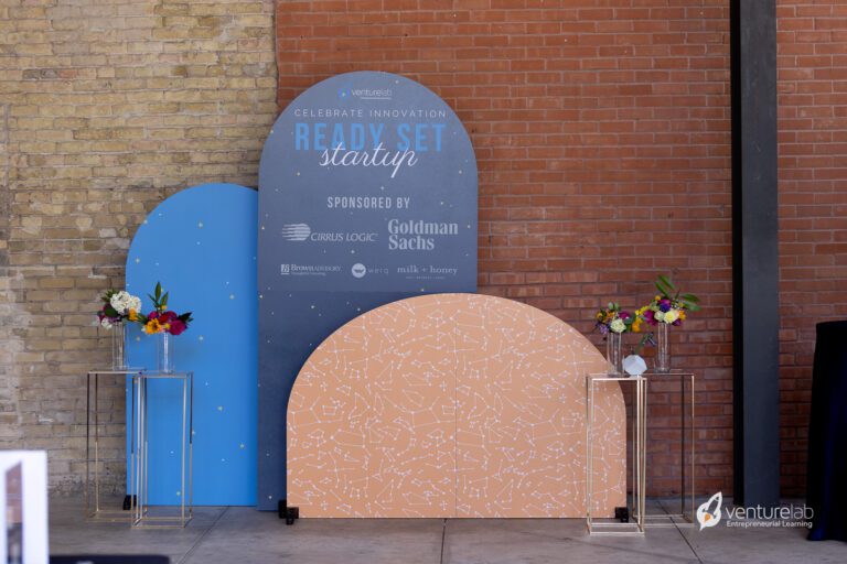 A brick wall with a large curved display reading 