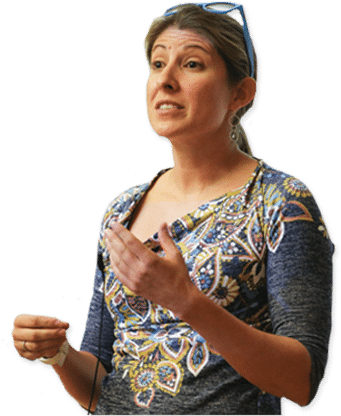 A woman, wearing a patterned top and a headset, gestures while speaking about youth entrepreneurship education.