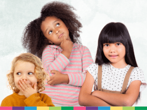 Three children stand together, each with a different expression: one thoughtful, one smiling with crossed arms, and one covering their mouth playfully. It's as if they're characters from a body language game, using their poses to communicate without words.