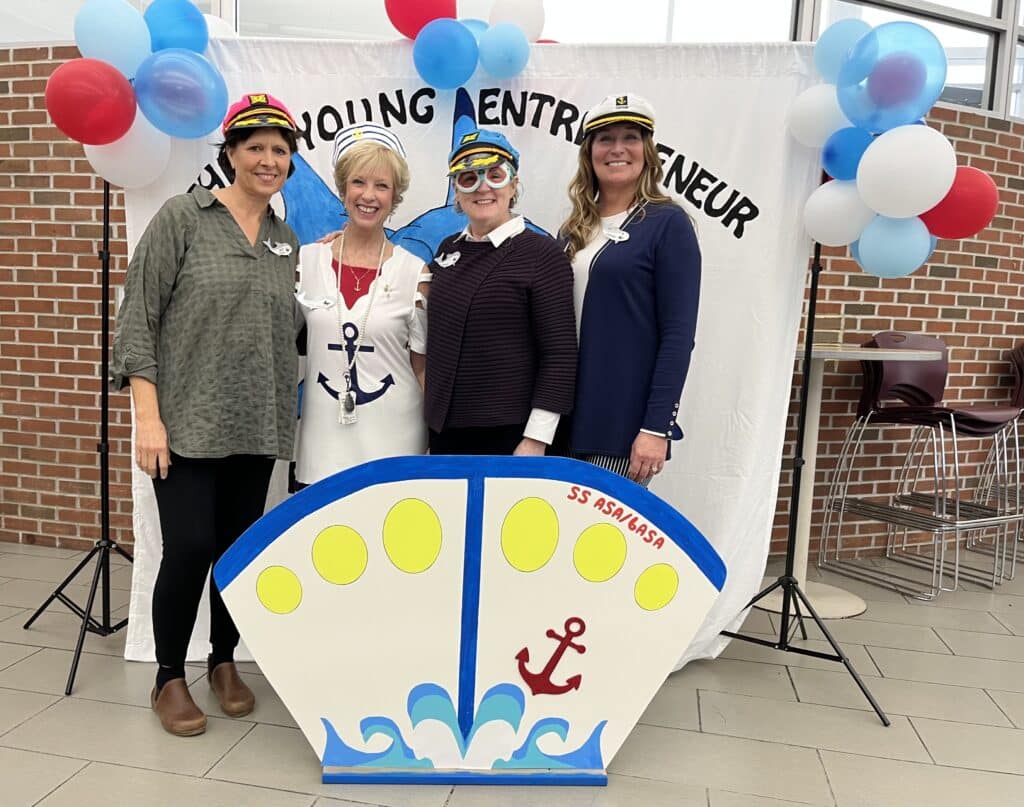 Liz Nusken standing with three other educators
