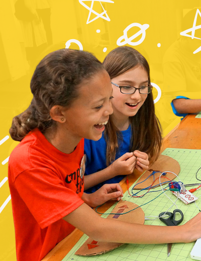 Two girls laughing while sharing their entrepreneurial skills.
