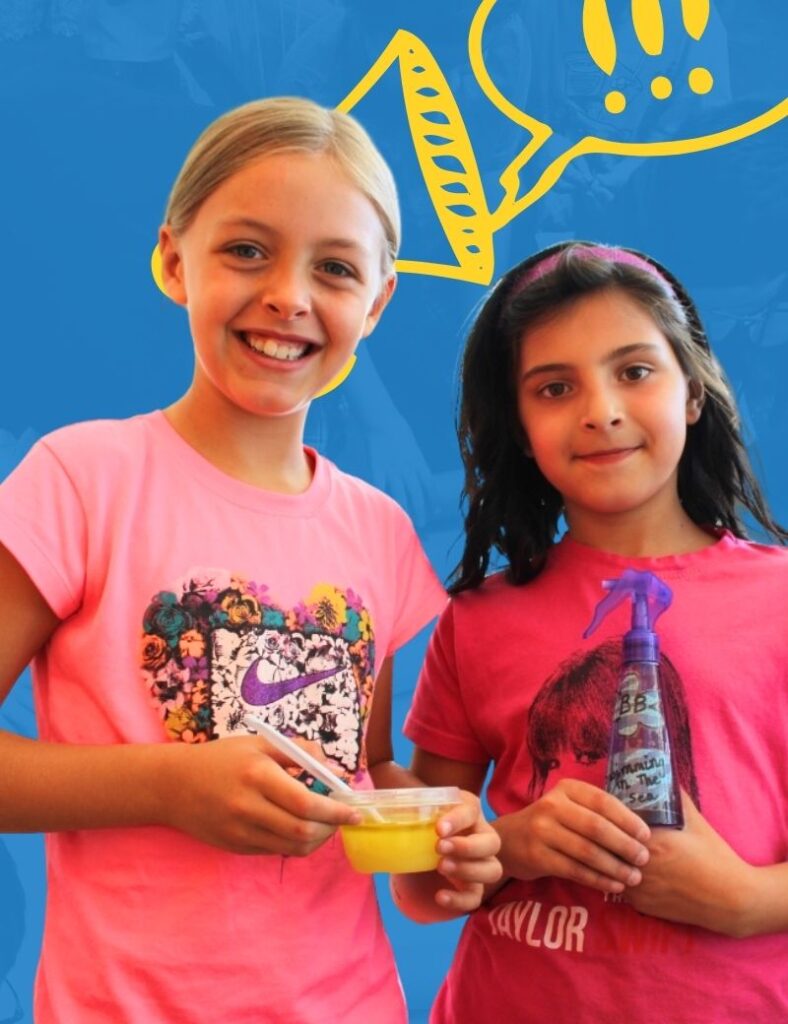 Two young girls proudly displaying their product ideas. One holds a jar of slime and the other holds a spray bottle