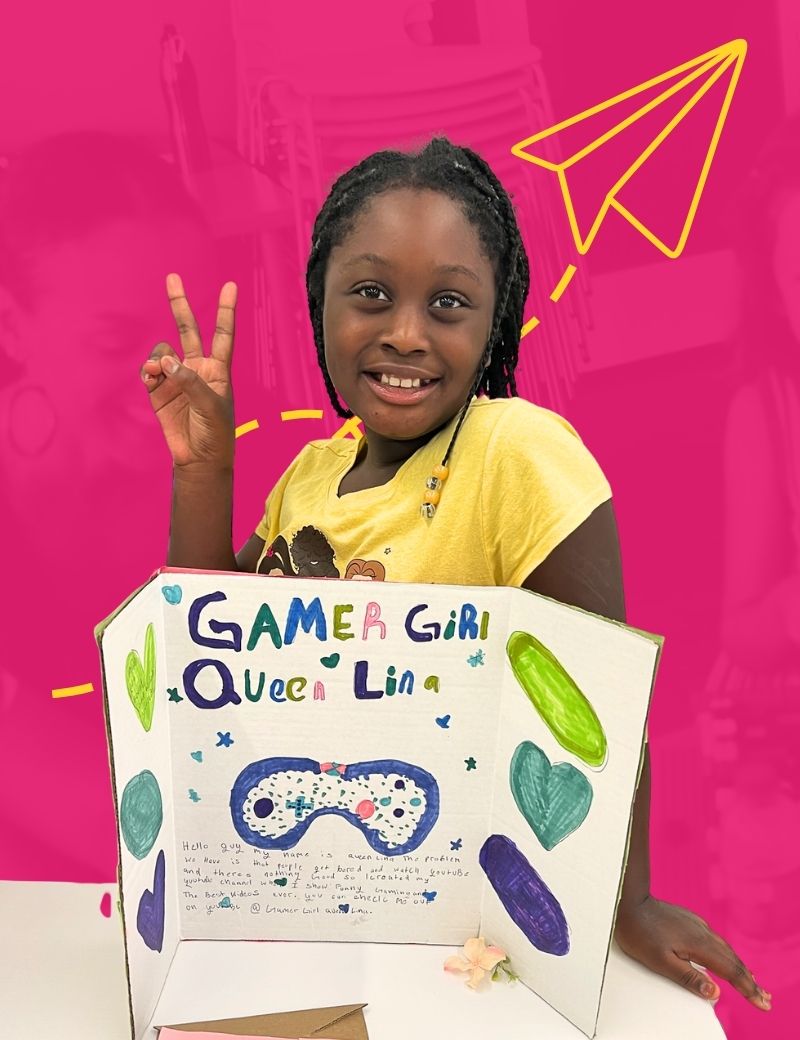 A girl, embodying the spirit of youth entrepreneurship, proudly displays her business idea on a hand drawn display board that reads, "Gamer Girl Queen Lina"